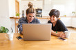 © David Fuentes/ADDICTIVE STOCK - Two beautiful and young women having breakfast at home and using the laptop