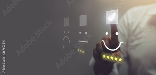 Fotografía Businessman pressing smiley face emoticon on virtual touch screen