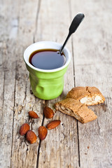 Wall Mural - Cup of coffee, fresh Italian cookies cantuccini and almond nuts on ructic wooden table background.