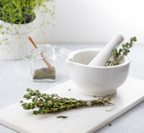 Fototapeta Lawenda - green thyme on the white mortar herbal aroma spicy health  wood
