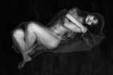 nude portrait of Asian model on wooden floor