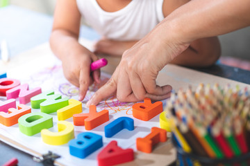 Asian little girl is learning English letters.