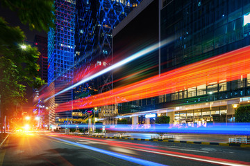 Poster - abstract image of blur motion of cars on the city road at night，Modern urban architecture