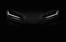 Silhouette Of Black Sports Car With LED Headlights On Black Background
