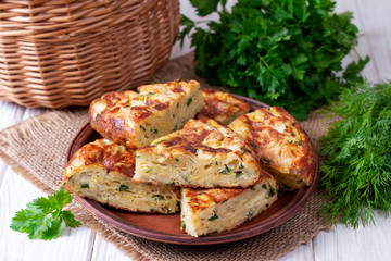 Wall Mural - Pie with zucchini, cheese and herbs on the table