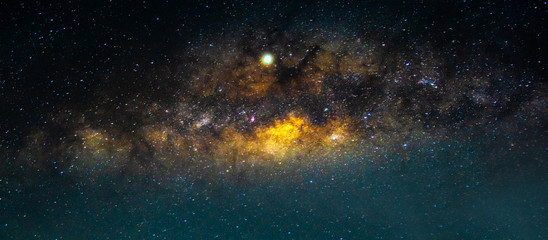 night scenery with colorful and light yellow milky way full of stars in the sky in summer beautiful 