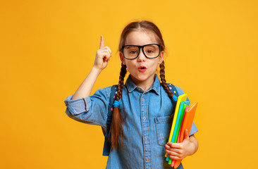 funny child school girl girl on yellow background .