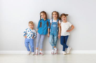 Wall Mural - happy kids friends around empty walls.