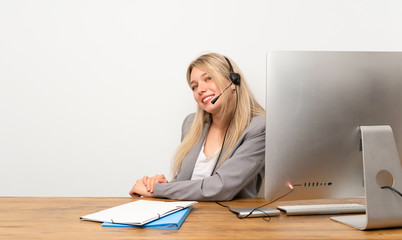 Wall Mural - Young woman working with headset laughing