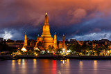Fototapeta Paryż - Wat Arun, at Chao Phraya river at sunset, Bangkok, Thailand.