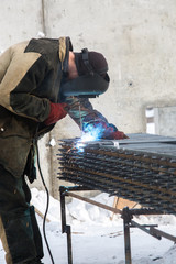 Welding work. Welder. Welding metal fittings. Male welder Construction works.