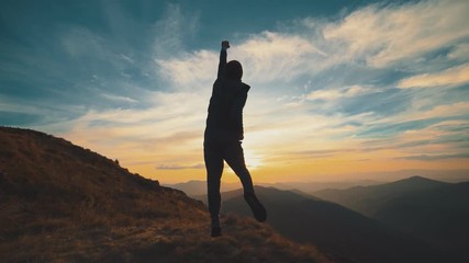 Wall Mural - the man running on the mountain against the beautiful sunrise. slow motion