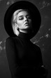 black and white portrait of beautiful fashionable blonde girl in hat