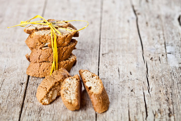 Wall Mural - Fresh Italian cookies cantuccini stack and almond seeds on ructic wooden table background.