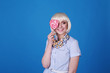 © Nadejda - Sexy beauty blonde eating a lollipop. Summer mood. Glamor woman model licks sweet multicolored candies on blue background