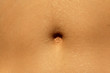 Closeup - navel of the stomach - belly button. Slim nude young woman belly.