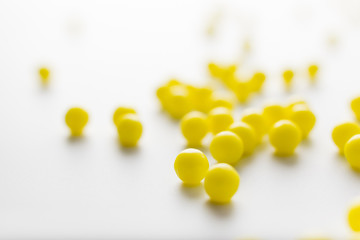 Wall Mural - yellow pills of vitamins on a white background for the medical treatment of diseases in the hospital