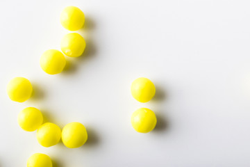 Wall Mural - yellow pills of vitamins on a white background for the medical treatment of diseases in the hospital