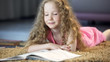 © motortion - Smart young girl reading interesting book, literature for children, education