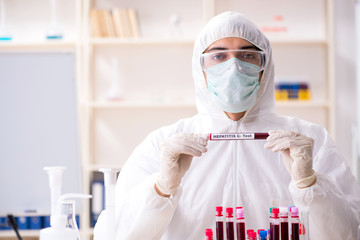 Young handsome chemist working in the lab 