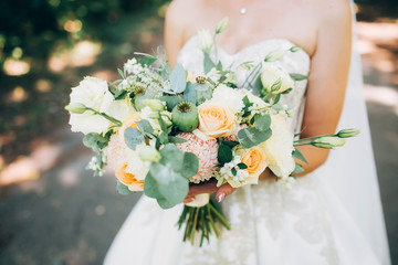 Poster - wedding bouquet with white carnations and ranunculi. delicate bouquet in yellow and white. eucalyptus leaves.