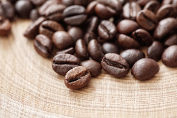Poster - Coffee  beans on natural wooden texture background. Coffee background or texture concept.