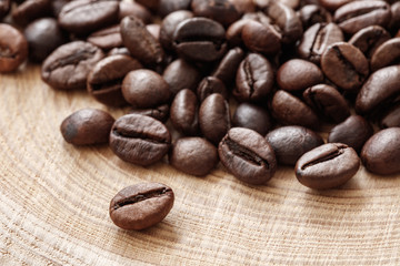 Poster - Coffee  beans on natural wooden texture background. Coffee background or texture concept.