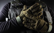 Warrior soldier in tactical gloves standing front view closeup.