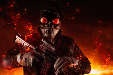 Wall Mural - Soldier in skull mask, rifle, glasses and beret face front view.