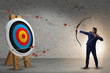 © Elnur - Businessman aiming arrow with bow