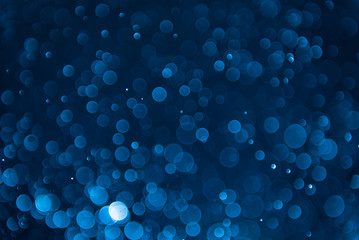 glitter lights abstract dark blue background. defocused bokeh dark illustration