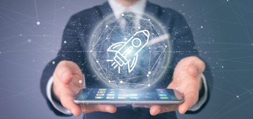 Poster - businessman holding a start up rocket on a sphere 3d rendering