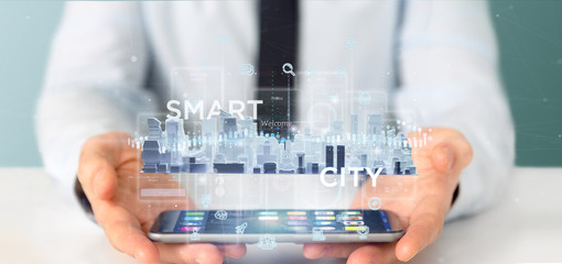 Poster - Businessman holding Smart city user interface with icon, stats and data 3d rendering