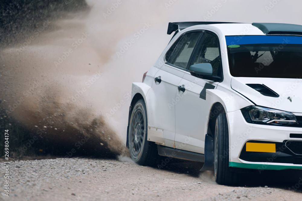 Rally car in motion with the clouds of dust. Sports car take a turn at ...