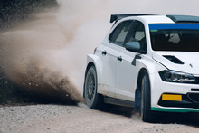 Rally Car In Motion With The Clouds Of Dust