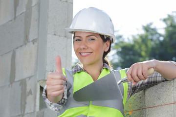 portrait of female constructor showing like gesture