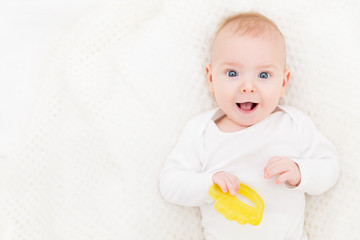 Happy Baby, Cute Infant Kid Playing with Teether Toy, Smiling Boy Portrait, Six Months Old