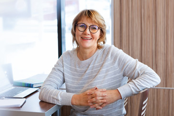 woman working on laptop in cafe, office