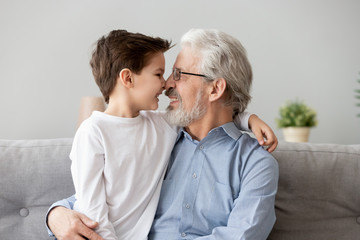 Wall Mural - Happy grandfather have fun touch noses with grandchild