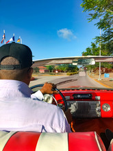 The Cuban Driver Of A Cabriolet Driving The Car.