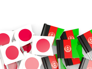 Pins with flags of Japan and afghanistan isolated on white.