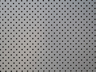 Metal texture with regular holes. Decorative facade panel