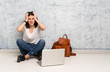 © luismolinero - Student woman sitting on the floor frustrated and takes hands on head