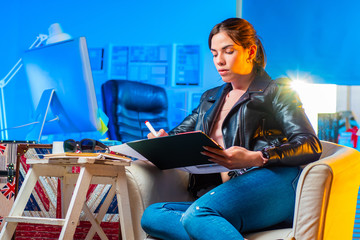 Poster - supernumerary designer. freelance girl designer takes notes when developing a mobile application pro