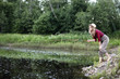 © alexkich - Girl by the river with a fishing rod