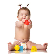 Infant Child Baby Toddler Sitting Naked In Diaper With Yellow Blue And Red Educational Toys Playing Isolated