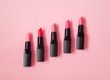 Set of beautiful lipsticks on pink background
