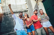 © Mediteraneo - Young happy tourists sightseeing in city