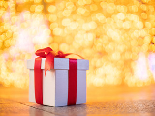 White gift box with yellow bokeh circle light background