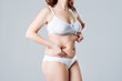© staras - Woman with fat flabby belly, overweight female body on gray background